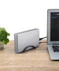 Beefy Aluminum 3.5 Inch Hard Drive Enclosure With Hassle Free USB 3.0 To Sata Docking, connected to a laptop on wooden table.