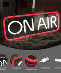 On air neon sign displayed lit on plush surface with USB cable; Happy Birthday Neon Sign Wall Decor 16x12 Inch Neon Light With Low Energy Consumption Easy Install Wide Application For Parties Home Bars Dorm Rooms Durable Plastic Perfect Party Vibes For Any Occasion.