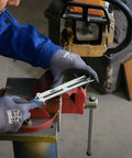 Person using Chainsaw Sharpening Files Set CS SLS 4.0 In Roll Bag, 4 mm Diameter, Five Thirty Second Inch File on a chainsaw chain.