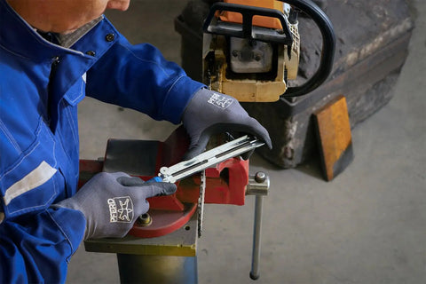 Person using Chainsaw Sharpening Files Set CS SLS 4.0 In Roll Bag, 4 mm Diameter, Five Thirty Second Inch File on a chainsaw chain.