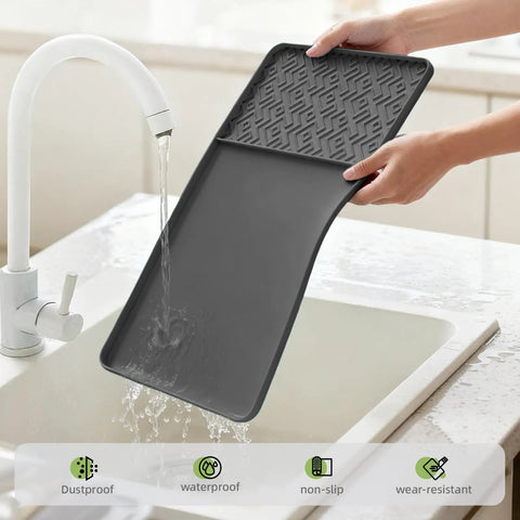 Raised Edges Silicone Coffee Mat 19 By 12 Inches Waterproof Countertop Protector being cleaned under running water