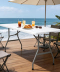 6 Ft Folding Table Outdoor Indoor Plastic Square Dining Table Portable No Assembly Easy Setup shown at beach deck with chairs