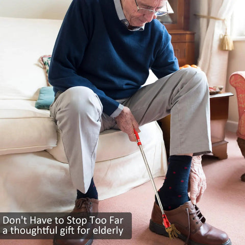 Elderly man using Magnetic Flashlight Pickup Tool With LED Telescoping Magnet Gadget In Red to pick up keys from floor