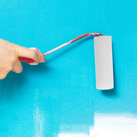 Hand using a white mini sponge roller for walls, part of the Twelve Pack Nifty Little Mini Sponge Rollers With Cushioned Handles For Walls And Detail Work Gives You A Straight Up Flawless Coat Every Time Super Simple Cleanup Built Solid For Daily Hustle.