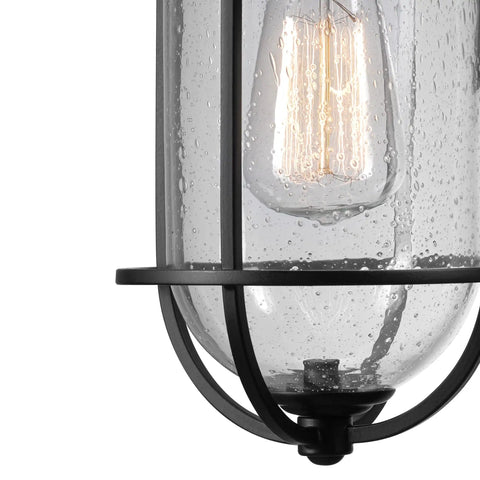 Close-up of the Outdoor Indoor Wall Sconce In Black Finish With Seeded Glass Shade, showcasing unique seeded glass texture.