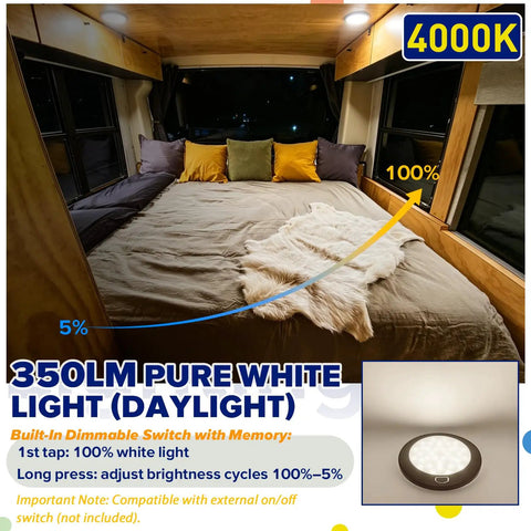 Interior view with bed illuminated by Durable Dimmable 5 Inch Black Round 12V RV Ceiling Light With Surface Mount LED Fixture.