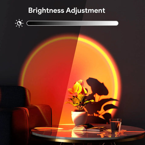 Sunset Lamp With Remote And 360 Degree Rotation projecting multicolor light on a plant and wall, brightness adjustment shown.