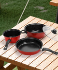 Portable Lightweight Nonstick Cast Iron Cookware Set With Glass Lids And Nylon Utensils 4 Piece on wooden table outdoors