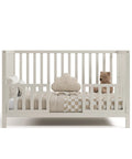Front view of crib with Storkcraft Toddler Safety Guardrail Kit With Slats In Frosted Oat Finish Dual Guard Rails For Crib To Toddler Bed