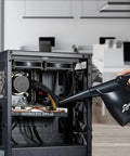 Person using High Power Electric Air Duster For Keyboard And Laptop Cleanup 110000 RPM Blower That Replaces Canned Air on computer case