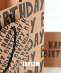 Large Kraft Birthday Gift Bag Set With Classic Black Happy Birthday Lettering Includes Greeting Card Hang Tag Kraft Envelope And Tissue Paper All In One Gift Kit For Men Boys And Kids close-up of bag and hang tag
