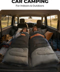 Two people using Lightweight 3lb Backpacking Sleeping Bag For Adults And Kids With Compression Sack inside a car for camping.
