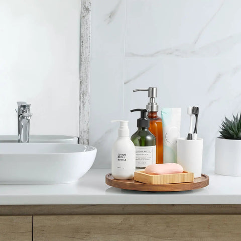 Bathroom scene with 10 Inch Acacia Wood Lazy Susan Turntable Organizer For Cabinet Round Serving Tray on countertop holding toiletries