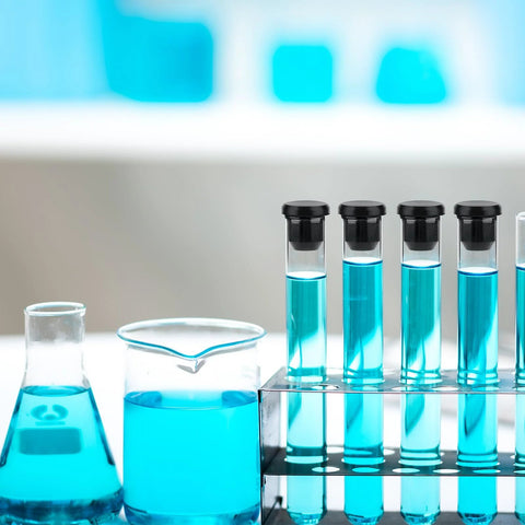 Test tubes with black caps in a rack, blue solution inside, showcasing 90 Pcs Silicone Rubber Hole Plugs Set In Assorted Sizes From 4mm To 9.5mm.