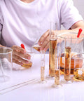 Person using Thick Wall Beaker And Graduated Cylinder Set For Science Lab Includes 5 Beakers 4 Measuring Cylinders 3 Droppers 4 Stirring Rods