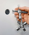 Hand holding TwinKey Multifunctional Spanner Kit With Magnetic Eight Arm Two By Four Way Spider Keys for control cabinets.