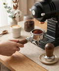 Hand using 54mm Espresso Portafilter With Two Cup Spouts And Walnut Handle For Breville And Sage Barista Machines Fits Barista Express Pro Touch Bambino Series Stainless Steel Basket with coffee machine