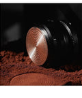 Close-up of Top Shelf Espresso Tamper And Coffee Distributor Combo With Dual Stainless Ripple Blades on coffee grounds.