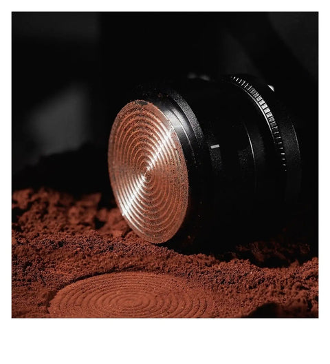 Close-up of Top Shelf Espresso Tamper And Coffee Distributor Combo With Dual Stainless Ripple Blades on coffee grounds.