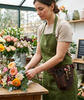 Florist arranging flowers wearing genuine leather florist tool belt gardening bag for gardeners and DIY pros with 3 pockets waist pouch holster brown leather 42 inches belt for gardening farm and workshop use.