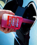 Storage Fuel Stabilizer For Long Term Fuel Freshness And Engine Protection Keeps Gasoline Fresh Up To 24 Months Treats 25 Gallons 10 Fl Oz being poured into a car's fuel tank
