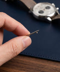 Close-up of hand holding a pin from Stainless Steel Watch Band Pin Replacement Kit With Quick Release Spring Bars And Strong Locking Force