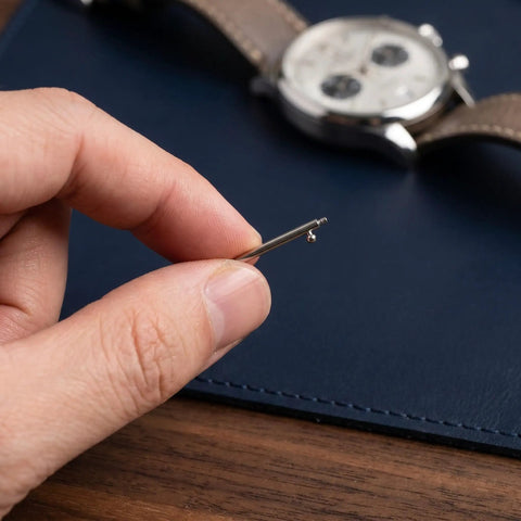 Close-up of hand holding a pin from Stainless Steel Watch Band Pin Replacement Kit With Quick Release Spring Bars And Strong Locking Force