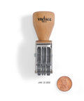 Vintage Pro Heavy Duty Date Stamp Workhorse Featuring Adjustable Mmm Dd Yyyy American Format with wood grip next to a penny.