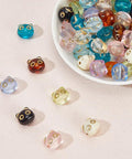 Colorful Acrylic Cat Beads Kit 100 Pcs, Cute 3D Cat Face Spacers for Jewelry Making displayed on a surface