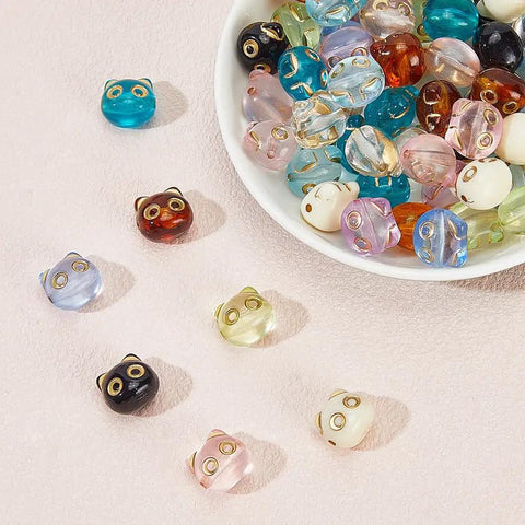 Colorful Acrylic Cat Beads Kit 100 Pcs, Cute 3D Cat Face Spacers for Jewelry Making displayed on a surface