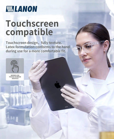 Person in lab coat using a tablet wearing 5 Mil Latex Disposable Gloves Food Contact Safe Powder Free Fully Textured Grippy White Large Size.