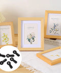 Black photo frame turn-button fasteners; 300-pack shown with four wooden frames
