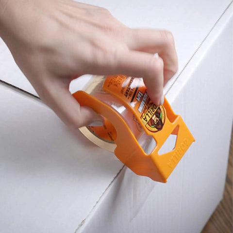 Person using Heavy Duty Packing Tape With Dispenser For Moving And Shipping, Extra Thick 3.4 Mil Crystal Clear Tape, 1.88in x 25yd