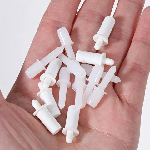 40 Pack Spring Loaded Shutter Repair Pins with Dual Sizes in hand, white plastic fasteners for blinds and cabinet hinges.