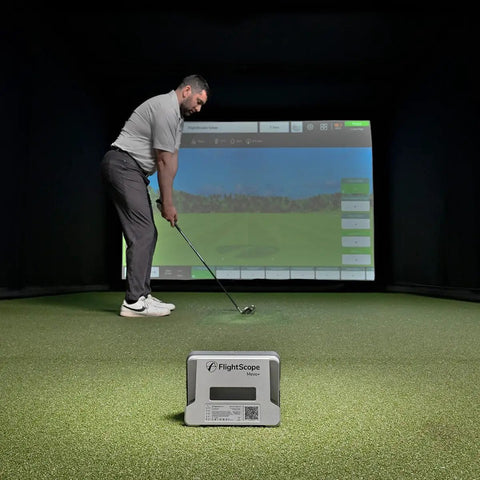 Man using Mevo Plus GPS Launch Monitor and Golf Simulator with Multicam Tracking indoors