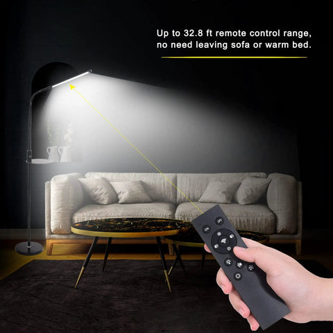 Hand using remote to adjust Gooseneck LED Floor Lamp with remote and touch control dimmable from 5 to 100 percent brightness in living room