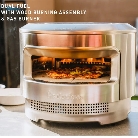 Pi Pizza Oven With Wood Or Gas Burner for Backyard Pizza Nights, stainless steel design with pizza on cordierite stone surface