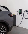 48 Amp Level 2 Wall Mounted Indoor Outdoor Fast Electric Vehicle Charging Station With 25Ft Flexible Cable Nema 14-50 Connector in garage beside vehicle.