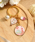 Tokyo Travel Keychain With Hot Air Balloon Ice Cream And Pearl Charms For Keys Cute Souvenir For Women Mt Fuji Silhouette Engraved Design Perfect Travel Keepsake For Japan Trips, displayed on a wooden surface.