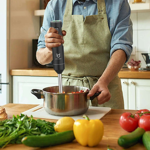 Total Game Changer Cordless Hand Blender With Whisk For Smoothies Soups And Baby Food Purees featuring a stainless blend rod in use.