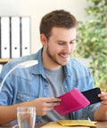Man placing phone in Hot Pink Bubble Mailers 4x8 Inch Pack Of 50 Waterproof Padded Envelopes at office desk