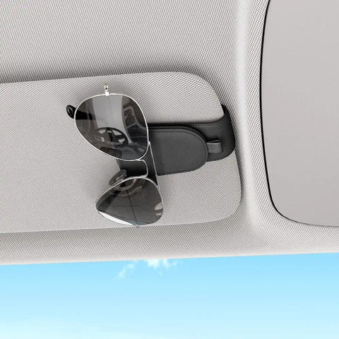 Premium Magnetic Sunglass Holder for Car Visor 2 Pack Soft Faux Leather Eyeglasses Clip holds sunglasses on car visor.