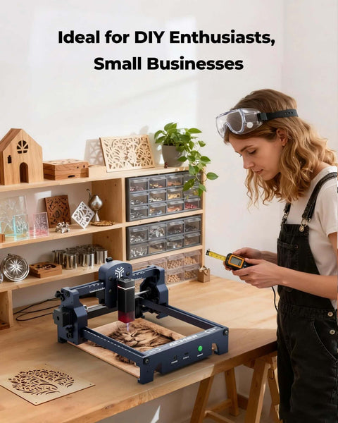 Front view of ACMER S1 laser engraver on wood workbench; blue-gray machine with 130x130mm work area and handheld controller
