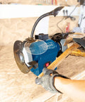 Heavy Duty Double Bench Grinder Boasts A Rock Solid 550 Watt Induction Motor For Noise Free Grindin Work With Adjustable Spark Guard and flex work lamp in use.