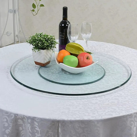 Rock Solid 360 Smooth Swivel Lazy Susan Turntable, Massive 34 Inch Tempered Glass Serving Platter on a dining table with fruits.