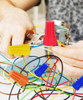 Person using pliers to assemble wires with Diyers Wire Nuts Assortment Kit 1500 Pcs Insulated Twist Connectors, 5 Sizes