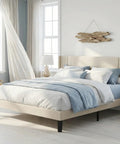 Prime Queen Bed Frame With Plush Wingback Headboard And Heavy Duty Steel Base For Ultimate Lounge Comfort And Durable Support To Kick Back And Rock Your Bedroom Setup in a light-filled room.