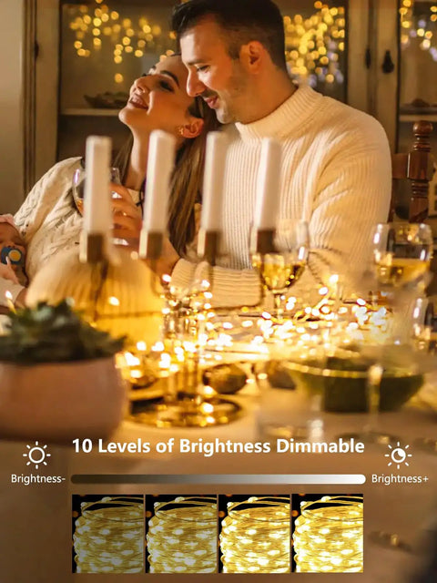 Couple enjoying dinner with 4 Pack 100 LED Fairy Lights Battery Operated With Remote 33Ft Waterproof Twinkle String Lights