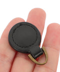 Five Piece Set Of Badass Black Alloy Zipper Pull Replacement Tabs For Heavy Duty Backpacks on a hand, showcasing black alloy material.