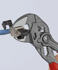 7.25 Inch Pliers Wrench With Smooth Jaws And Black Finish gripping a cable connector, showing red grip handle.